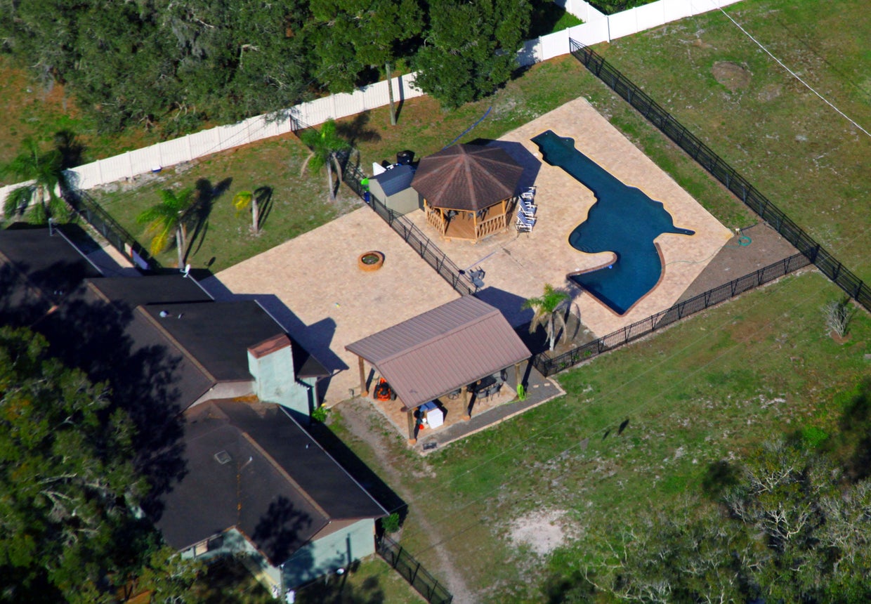 Custom built pool behind home near Tampa shaped like revolver - CBS Miami