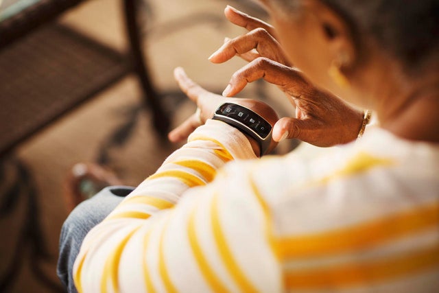 Close-up of senior woman using smart watch 