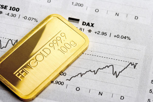 Gold bars and financial newspapers 