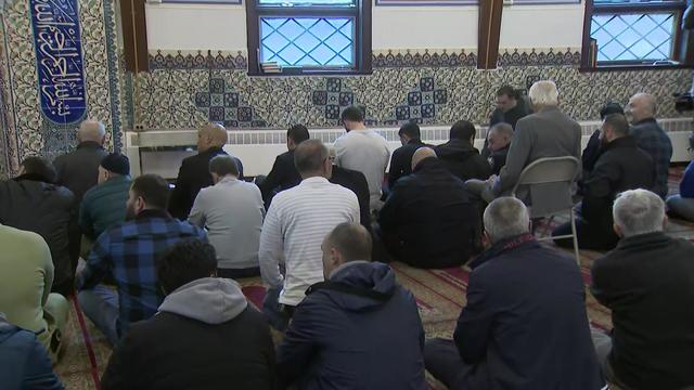 Men sit on the floor inside United Islamic Center, a Turkish mosque. 