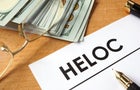 Page of paper with HELOC and dollars. 