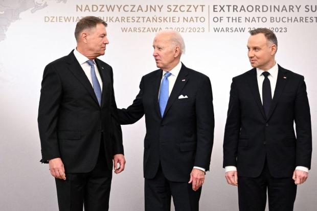 President Biden poses during a group photo with the Polish President Andrzej Duda and Romanian President Klaus Iohannis at the Presidential Palace in Warsaw on Feb. 22, 2023. 