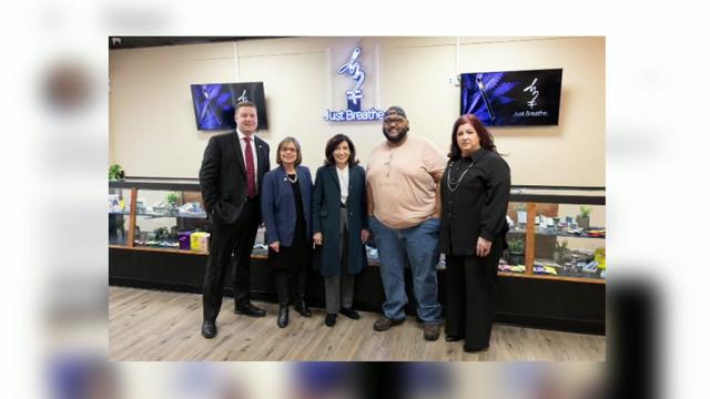 Gov. Kathy Hochul and others pose inside Just Breathe marijuana dispensary. 