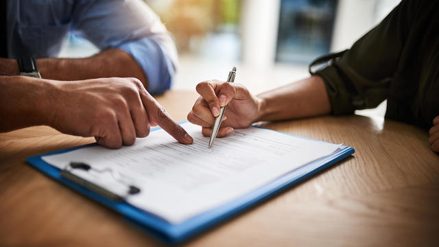 Lawyer, broker or HR manager signing a contract agreement with client or employee. Financial advisor asking for womans signature for insurance, legal paperwork or claim document 
