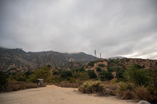 Landscape of Eaton Canyon hiking mountains trails with wild grass under gray sky 