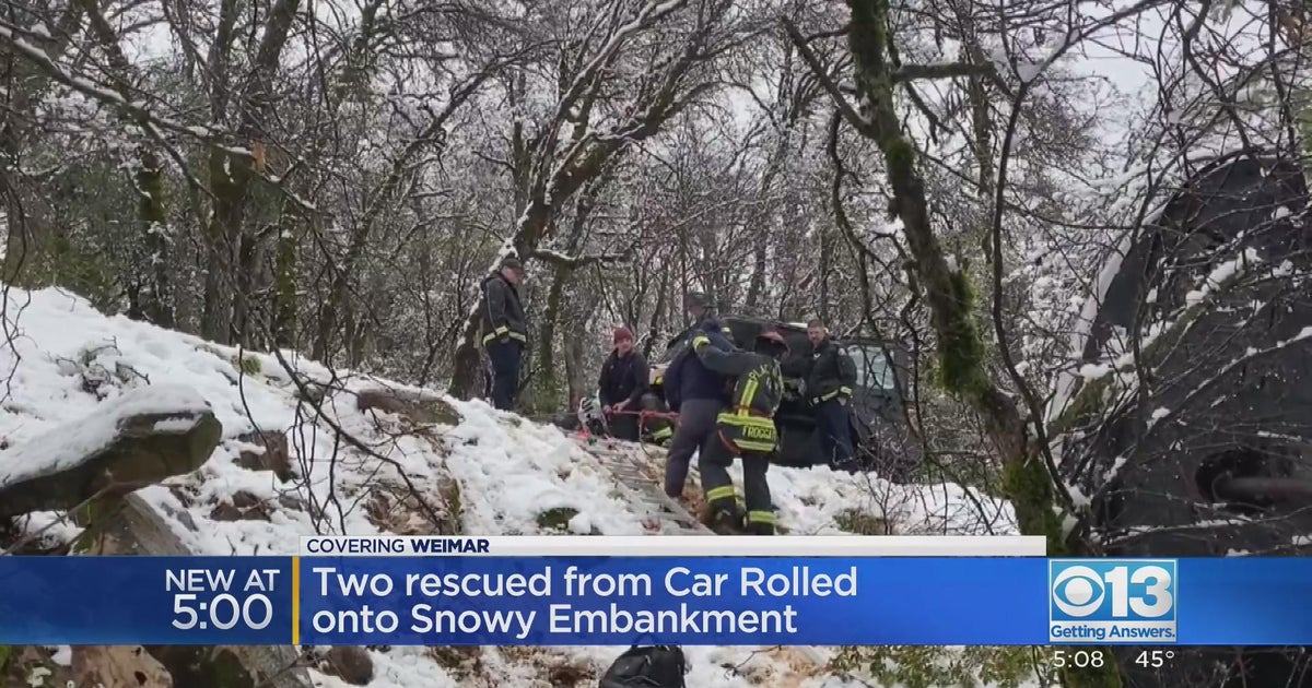 2 people rescued after car rolls onto snowy embankment in Weimar