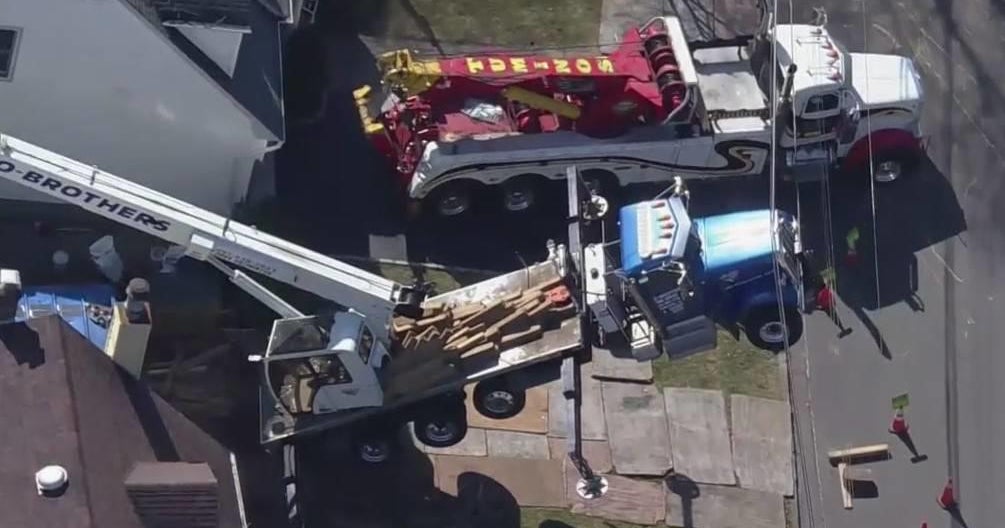 Crane topples over, sends front of truck into power lines in Cresskill