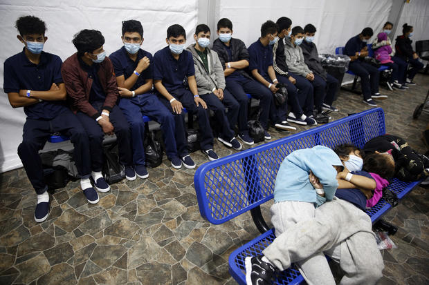 Young unaccompanied migrants wait for their turn at a processing station inside a Department of Homeland Security holding facility in Donna, Texas, on March 30, 2021. 