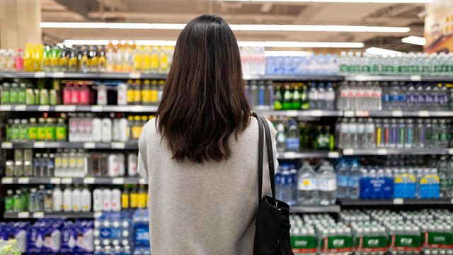 Back view of female millennial customers in supermarket 