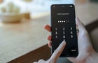 Close up woman hand holding smartphone while entering the passcode. Concept of personal information security 