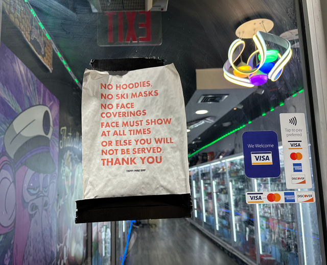 A sign in a glass door 