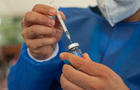 A nurse gets a dose out of a flu vaccine 