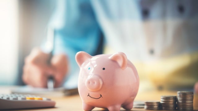 Businessman with a piggy bank 