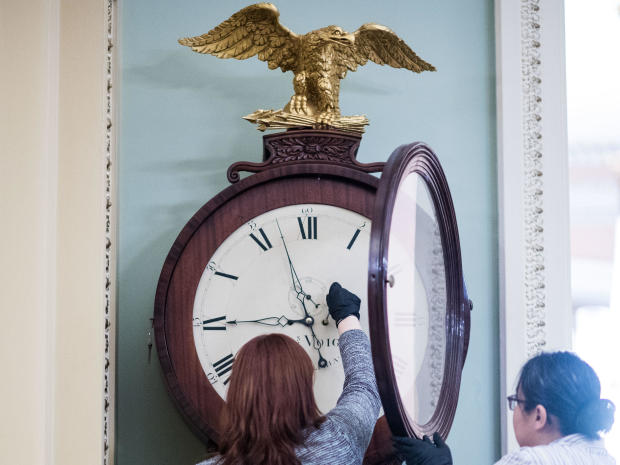 Capitol workers wind the Ohio Clock in the U.S. Capitol in Washington, D.C., on Jan. 21, 2020. 
