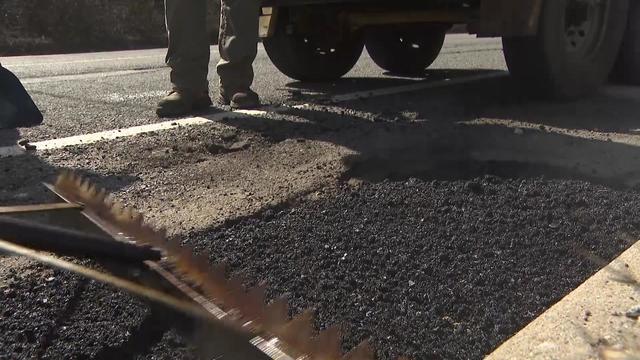 Crews repair a pothole on Long Island. 