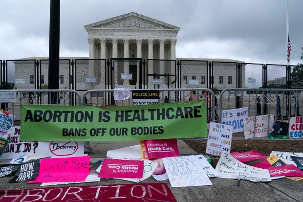 Abortion rights demonstrators leave banners at a fence outside of the Supreme Court in Washington, D.C., on May 14, 2022. 