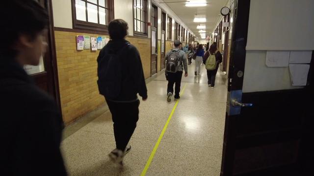 Students walk down a hallway in Bayonne High School. 