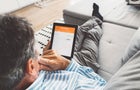Senior man looking at his savings on a tablet 