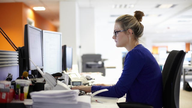Young woman using computer in office