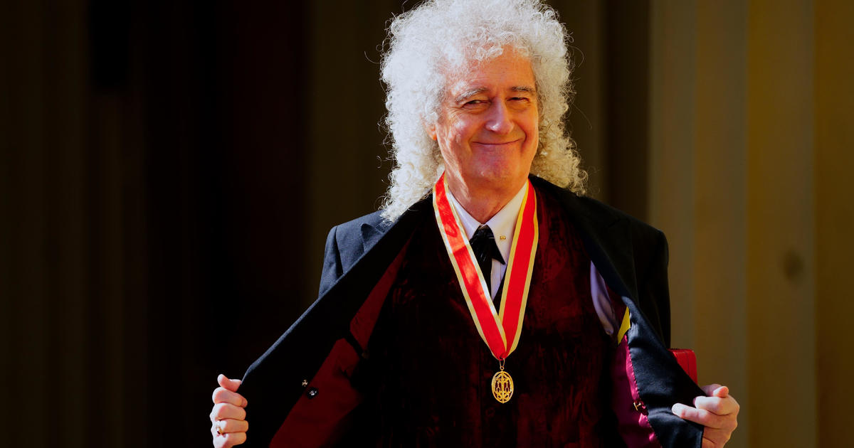 King Charles knights Brian May, of rock group Queen, at Buckingham Palace