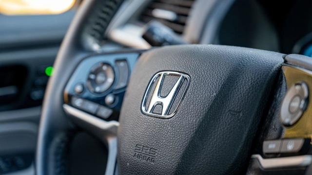 In this photo illustration, a Honda logo is displayed on the 