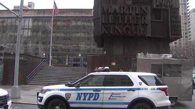 A NYPD vehicle sits parked outside Martin Luther King High School. 