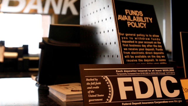 Signs explaining Federal Deposit Insurance Corporation and other banking policies are shown on the counter of a bank in Westminster, Colorado, November 3, 2009. 