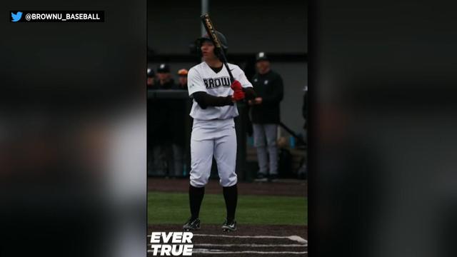 Olivia Pichardo in uniform holding a baseball bat 