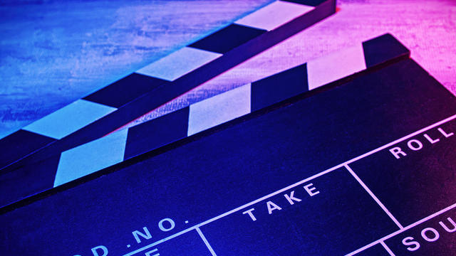A clapperboard, symbol of filmmaking and video production. 