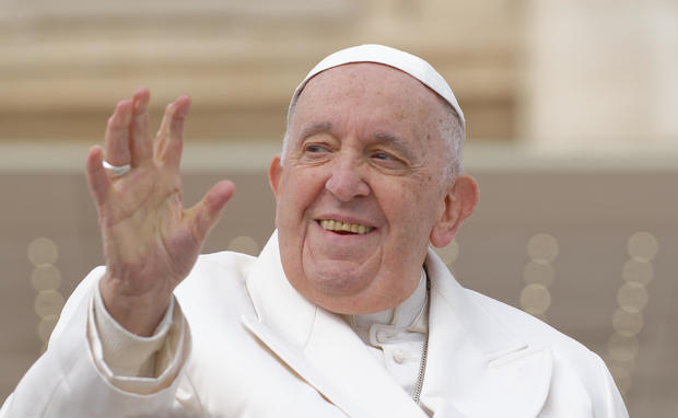 Pope Francis waves from the "popemobile" as he leaves St. Peter's Square on March 29, 2023, at The Vatican to hold his weekly general audience. 