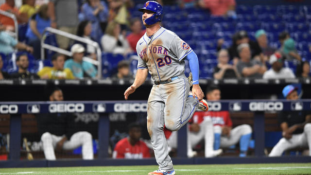 New York Mets' Pete Alonso scores on a double by Starling Marte during the ninth inning of the team's baseball game against the Miami Marlins, Saturday, April 1, 2023, in Miami. 