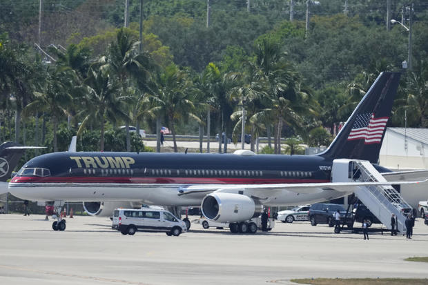 Former President Donald Trump boards his plane at Palm Beach International Airport, Monday, April 3, 2023, in West Palm Beach, Florida. 