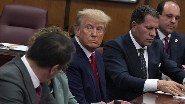 Former President Donald Trump sits with his attorneys inside the courtroom during his arraignment at the Manhattan Criminal Court on April 4, 2023, in New York City.  