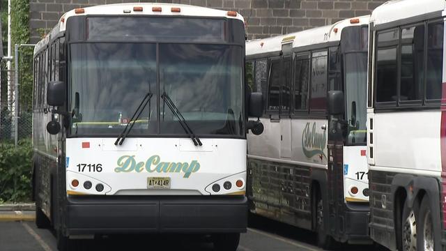 DeCamp commuter buses parked in a parking lot. 