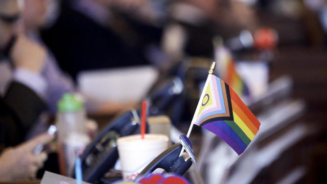A flag supporting LGBTQ+ rights decorates a desk on the Democratic side of the Kansas House of Representatives during a debate on March 28, 2023, at the Statehouse in Topeka, Kansas. 