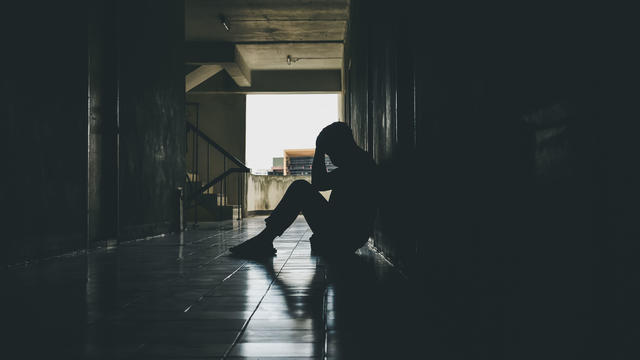 Dramatic, Silhouette of Sad Depressed man sitting head in hands on the floor. Sad man, Cry, drama, lonely and unhappy concept. 