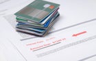 Stack of credit cards on account of value in red 