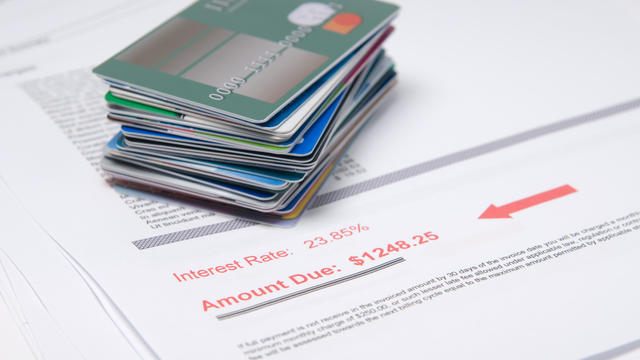 Stack of credit cards on account of value in red 