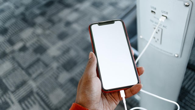 Woman Charges Her Smart Phone at Airport 