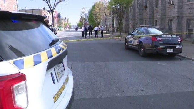 Police vehicles with overhead strobe lights at a crime scene 