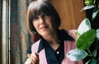 English fashion designer and fashion icon Mary Quant, wearing pink buttoned vest and black shirt underneath, circa 1975. 