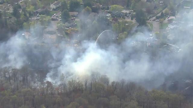 An aerial view of a cloud of smoke over a wooded area in Rockland County. 