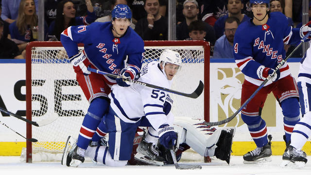 Niko Mikkola #77 of the New York Rangers defends against Noel Acciari #52 of the Toronto Maple Leafs during the second period at Madison Square Garden on April 13, 2023 in New York City. 