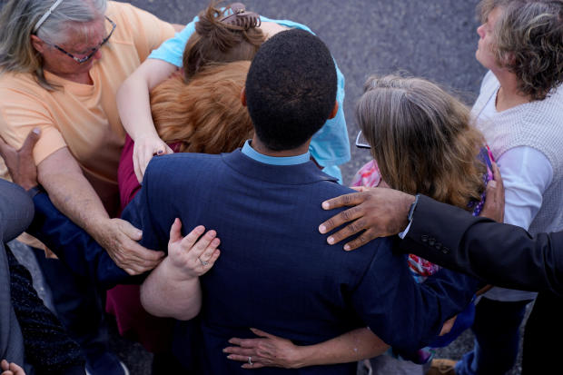 Community members embrace each other during a vigil the day after a shooting during a teenager's birthday party at Mahogany Masterpiece Dance Studio in Dadeville, Alabama, April 16, 2023. 