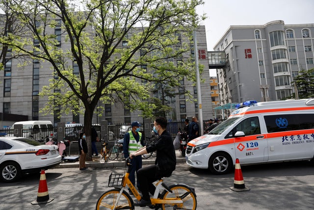 An ambulance parks outside the Changfeng Hospital following a fire, in Beijing 