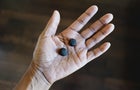 Woman Holds Gummy Nutritional Supplements in Palm of Her Hand 