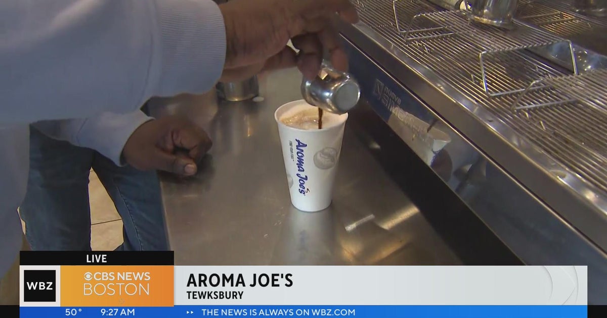 Levan Reid tests his barista skills at Aroma Joe's in Tewksbury CBS