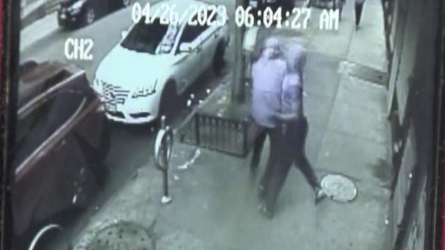Surveillance video shows a man punching a delivery driver on a sidewalk. 