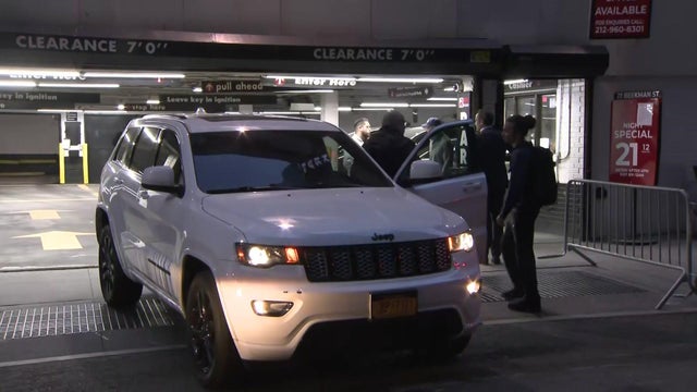 A parking garage attendant drives a vehicle out of a garage in the Financial District. 