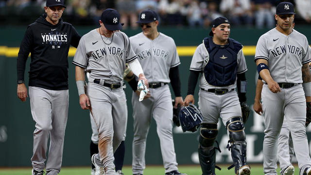 ake Bauers #61 of the New York Yankees walks off the field after slamming on to the outfield wall while fielding a fly ball against the Texas Rangers in the \bottom of the first inning at Globe Life Field on April 29, 2023 in Arlington, Texas. 